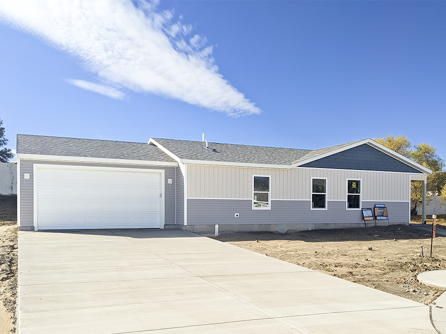 Ranch Style Tan white and blue new home with two car garage and farmhouse style exterior by Smart Dwellings